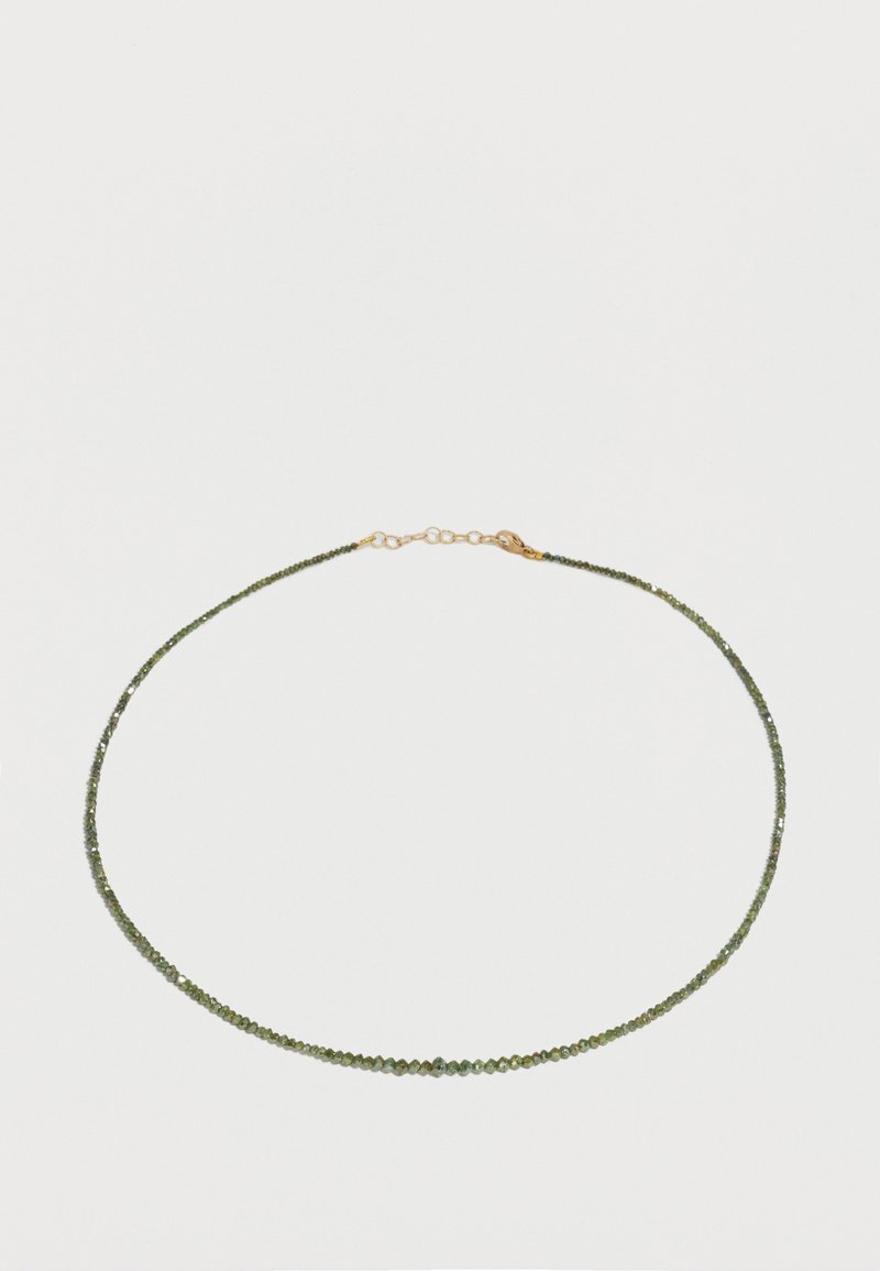 Λεπτό κολιέ με μικρές σκαλιστές πράσινες χάντρες και κούμπωμα σε χρυσό τόνο σε λευκό φόντο.