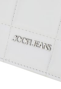 White leather wallet featuring quilted pattern and silver-toned "JOOP! JEANS" logo. Smooth texture with visible stitching details.