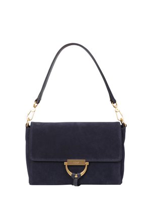 Navy suede handbag with a fold-over flap, gold-tone hardware, and a detachable leather shoulder strap. Features a circular accent at the front.