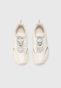 Pár Off-white sportcipő mintás fűzőkkel, párnázott nyakkal és húzófülekkel, felülnézetből, egyszerű háttér előtt.