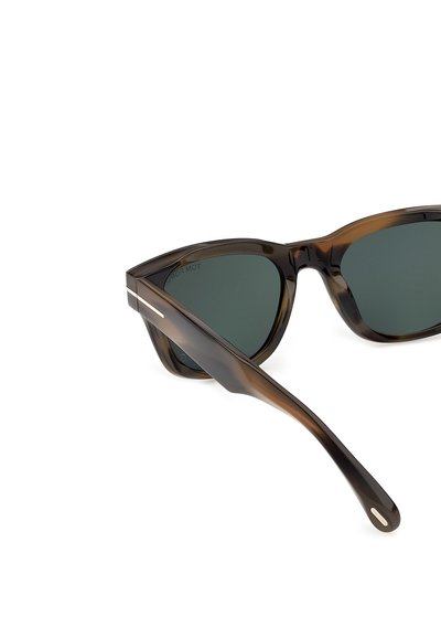 Tortoiseshell frame sunglasses with dark green lenses, featuring a silver accent on the temple arm and a subtle logo near the end.