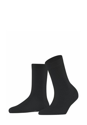 Black socks featuring a textured herringbone pattern. Mid-calf length with a reinforced toe and cuff, made from a flexible, breathable material.
