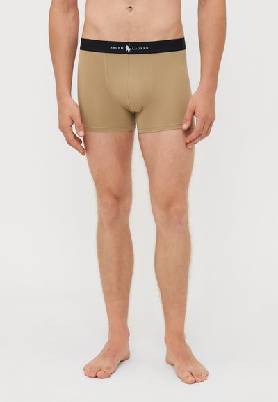Beige bokserice z črnim elasti�čnim pasom, ki nosi logotip "Ralph Lauren". Gladka tkanina s prilegajočim se dizajnom.