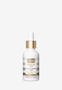 Weiße Flasche mit runder Basis, goldener Hardware und Tropfpipette. Aufschrift enthält "James Read" und "Gradual Tan H2O Tan Drops Face." 30 ml.