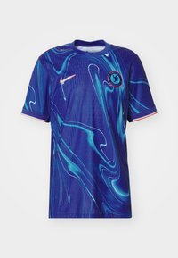 Plava nogometna majica s apstraktnim uzorkom spirale u svjetlijoj plavoj boji. Ima Nike logo i grb kluba na prsima, okrugli izrez i kratke rukave.