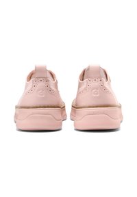 Pink athletic shoes with a smooth leather upper, perforated details, and a rubber sole. Features a pull tab at the back and "ZEROGRAND" branding.