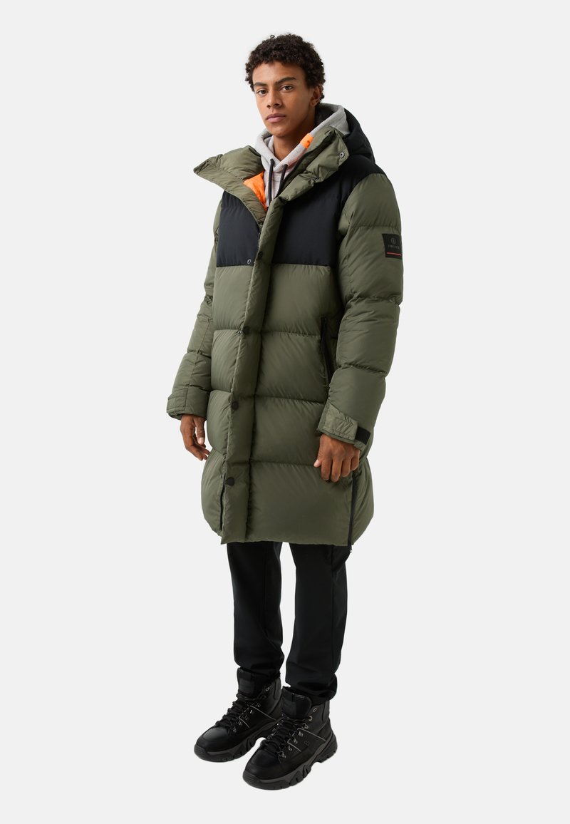 Olive green puffer coat with black upper sections, hood, and orange accents. Features a long cut, snap buttons, and side pockets.