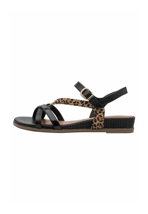 Black and leopard print sandals feature cross straps, an adjustable ankle strap, and a textured sole with a low wedge heel.