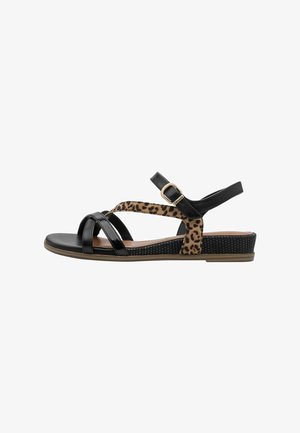 Black and leopard print sandals feature cross straps, an adjustable ankle strap, and a textured sole with a low wedge heel.