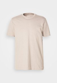 T-shirt beige à col rond, à manches courtes, au design sobre et à la texture légère, présenté sur un fond blanc.