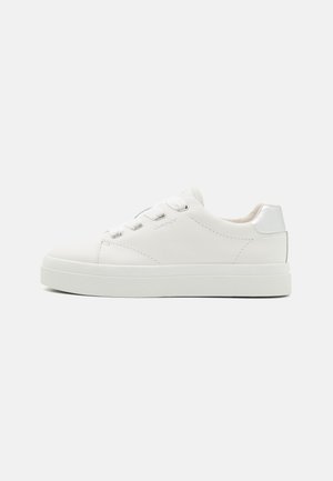 White leather sneaker with a smooth finish, rounded toe, flat white sole, silver heel accent, and six lace eyelets. Logo embossed on the side.