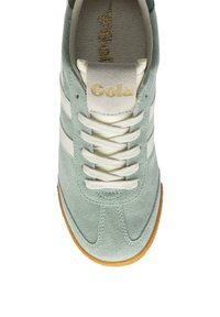 Baskets en daim vert clair avec des bandes et des lacets blancs. Présente une semelle intérieure texturée et une semelle extérieure en caoutchouc couleur gomme. Logo "Gola" en or sur la languette.
