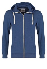 Sudadera azul con cremallera fabricada en una mezcla de algodón. Cuenta con una cremallera frontal, capucha con cordones y dos bolsillos frontales, además de puños y dobladillo acanalados.