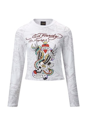 White long-sleeve shirt featuring a colorful tattoo-inspired graphic with a skull, wings, and "New York City" text. Soft fabric, cropped design.