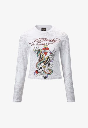 Witte langemouwen shirt met een kleurrijke tattoo-geïnspireerde grafiek van een schedel, vleugels en de tekst "New York City". Zachte stof, cropped ontwerp.