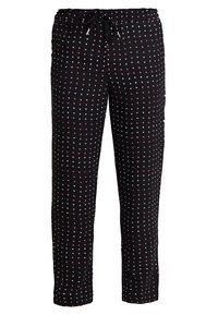 Pantalon noir à coupe ample, doté d'une taille à cordon de serrage. Décoré de pois rouges et blancs. Tissu lisse avec une texture douce.