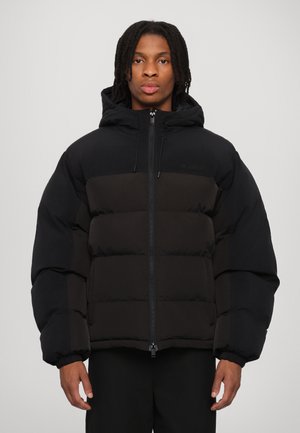 Black puffer jacket with a hood, featuring a quilted design, front zipper, and elastic cuffs. Material has a smooth, soft texture.