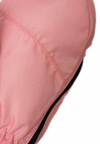 Close-up of a pink padded fabric section with detailed stitching and a black edge trim.