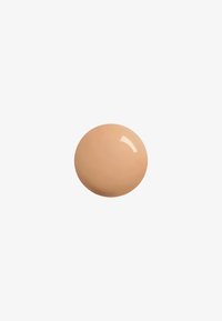 Beige cream in a round shape, smooth texture with a glossy finish, against a white background. No visible patterns or accents.