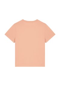 T-shirt à manches courtes en coton pêche, avec un col rond et une texture lisse sans motifs ni accents supplémentaires.