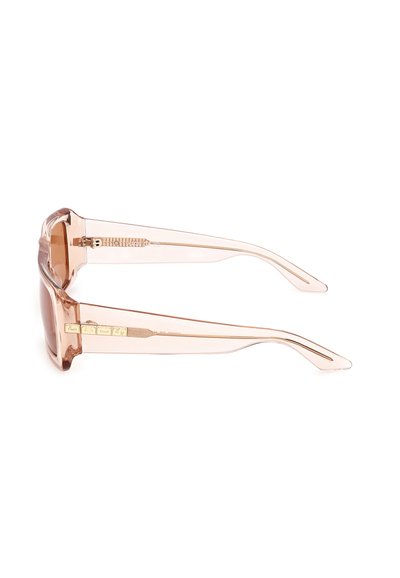 Pink transparent sunglasses with a chunky frame, brown lenses, and gold accents on the temples. Lightweight plastic material.