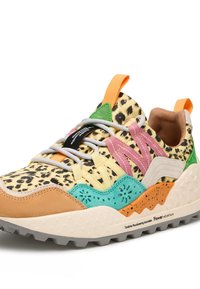 Multicolored sneaker featuring a leopard print upper, pink and green accents, a tan suede toe cap, and a rugged gray outsole.