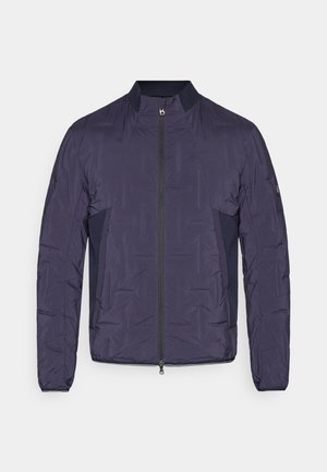 Navy blue lightweight quilted jacket with front zipper, ribbed collar, side mesh panels, and long sleeves.
