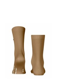 Calze beige al ginocchio con motivo a righe verticali, texture liscia e marchio stampato bianco di lato. Design semplice e funzionale.