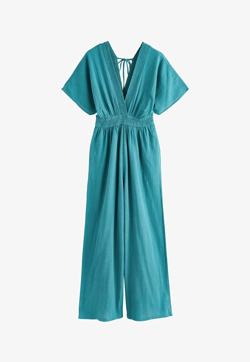 Combinaison bleu sarcelle à jambes larges avec manches courtes, décolleté en V profond, taille cintrée et détail de lien dans le haut du dos.