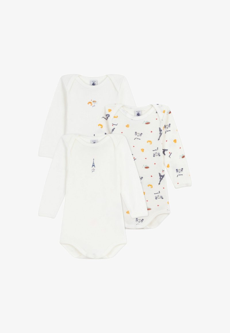 Three long-sleeve bodysuits: two solid white with subtle designs, and one patterned with Eiffel Towers and colorful accents. Made from soft cotton.