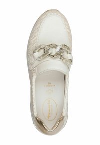 Zapatilla blanca con parte superior de tela texturizada, que presenta una cadena decorativa en la parte delantera. Suela de goma y detalles dorados en el talón.