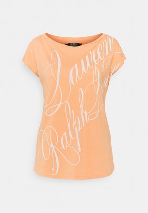 Peach-colored t-shirt, short sleeves, round neckline, featuring large white cursive text. Soft cotton material, relaxed fit.