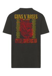 Black cotton t-shirt featuring red and yellow graphic print. Design includes "GUNS N' ROSES" and "APPETITE FOR DESTRUCTION" with 1987 tour dates.