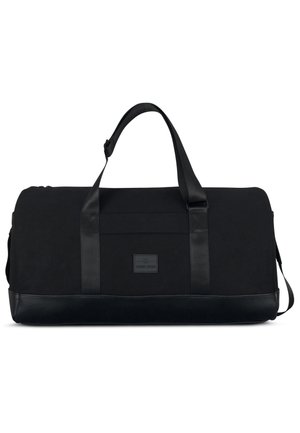 Black duffel bag made of durable canvas with a smooth leather bottom. Features dual handles and a front logo patch with minimal detailing.
