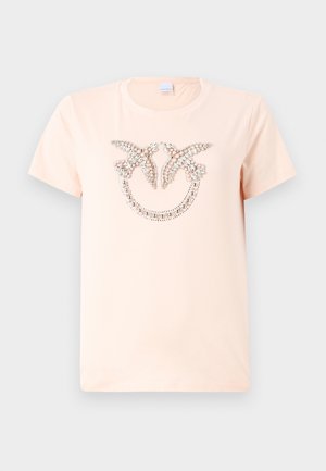 T-shirt di cotone rosa chiaro con maniche corte e scollatura rotonda, caratterizzata da un design decorativo di perline e strass sul davanti.