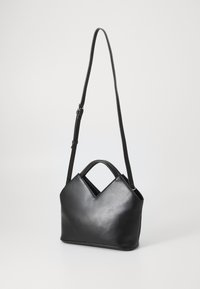 Black leather shoulder bag with a V-shaped top, a detachable strap, and dual handles. Smooth texture, minimalist design.