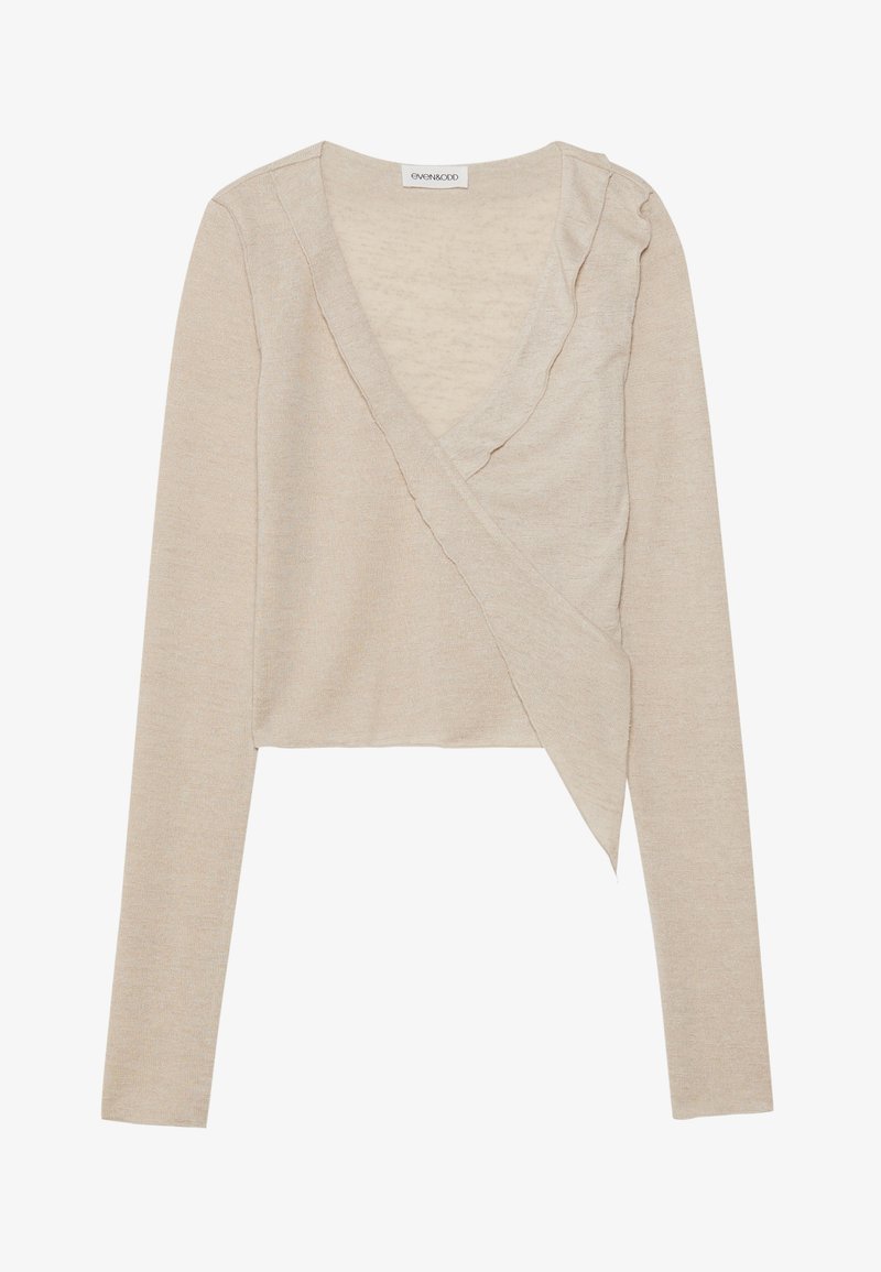 Beige wrap top with long sleeves, a v-neck, and ruffled trim along the neckline. Made of soft, textured knit fabric. Cropped design.