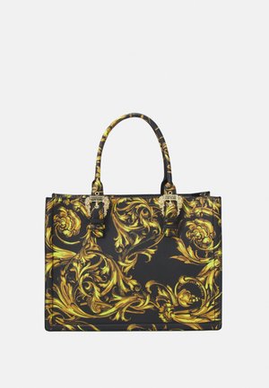 Sac tote noir avec motifs floraux baroques dorés ornés et doubles poignées supérieures, avec des accents de quincaillerie dorée.