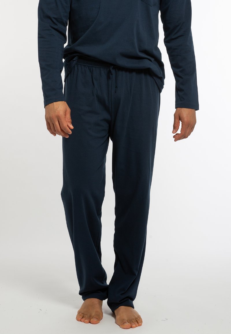 Marineblaues Langarmoberteil mit Tasche und dazugehörigen Joggingpants mit Kordelzug, aus weichem Stoff, mit lockerer Passform und minimalistischem Design.