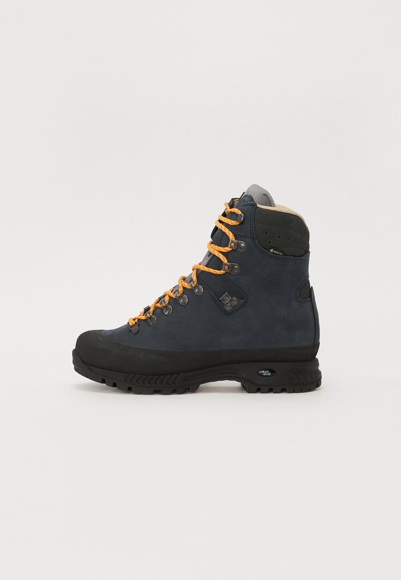 Bota de caminhadas com um cabedal em couro azul escuro, atacadores laranja, um colarinho acolchoado cinza e uma sola de borracha preta com padrões de tração.