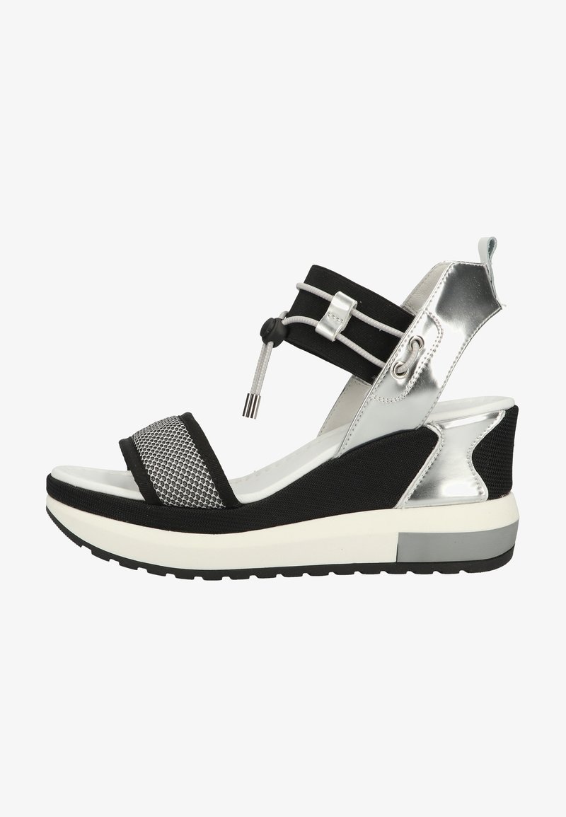 Black and silver sandal with mesh front strap, elastic ankle band, and chunky white midsole. Textured materials provide contrast and support.