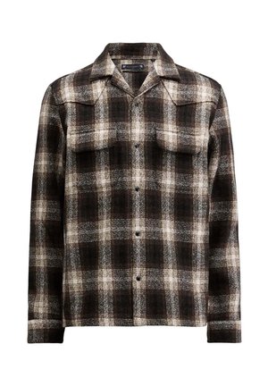 Camicia a quadri bianca e nera in un misto lana, con colletto a punta e due tasche sul petto, con chiusura a bottoni sulla parte anteriore.