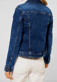 Blue denim jacket with a fitted shape, buttoned cuffs, and contrast stitching. The design features a classic collar and back yoke detail.