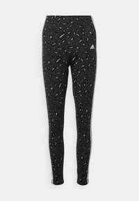 Black leggings with a textured leopard print pattern, featuring a wide elastic waistband and white side stripes. Made of a stretchy fabric.