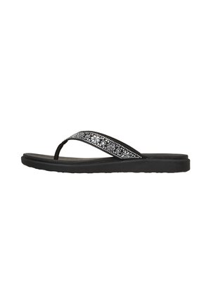 Zwarte slippersandalen met dikke zolen en een zwarte band versierd met zilveren bloem- en stippenpatronen.