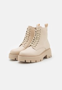 Tamaris Kotníkové boty na platformě - beige