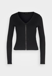 Cardigan lungo a maniche lunghe nero a costine con scollatura a V e chiusura con zip frontale. Realizzato in un materiale elastico, di forma aderente e con una textura liscia.