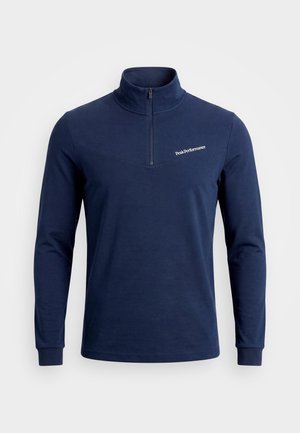 Marineblauer Langarmpullover mit halbem Reißverschluss am Kragen und "Peak Performance"-Logo auf der linken Brust.