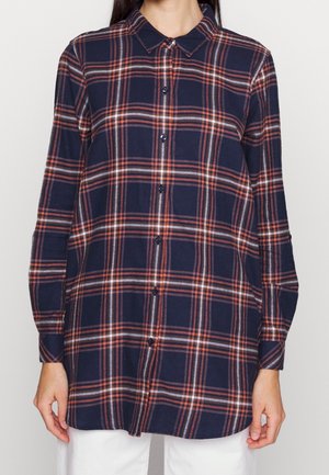 Marineblauwe geruite shirt met oranje en grijze lijnen, knoopsluiting aan de voorkant en lange mouwen. Gemaakt van zachte stof met een relaxte pasvorm.