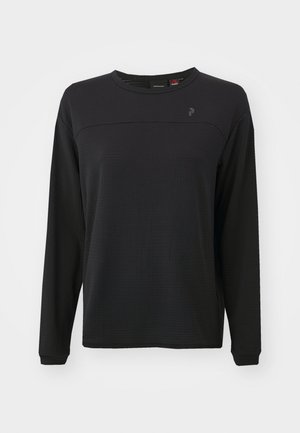 Black long-sleeve shirt with textured fabric, round neck, and a subtle logo on the chest. Features a relaxed fit and stitched detailing.